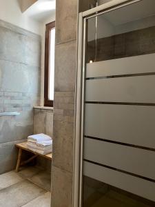 a shower with a glass door in a bathroom at Relais FraSimon Antico Casale in San Vito Chietino