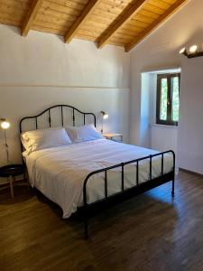 a bedroom with a large bed in a room at Relais FraSimon Antico Casale in San Vito Chietino +75 photos