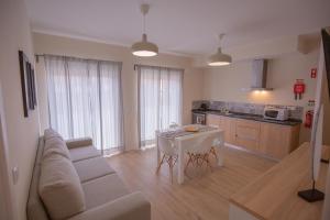 a living room with a couch and a table at Refúgio do Avô - Vale de Lourinhã in Lourinhã