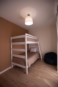 a bunk bed with a ladder in a room at Refúgio do Avô - Vale de Lourinhã in Lourinhã