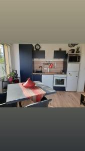 a kitchen with a table and a kitchen with a counter at Appartement T2 Lège Cap Ferret in Lège-Cap-Ferret