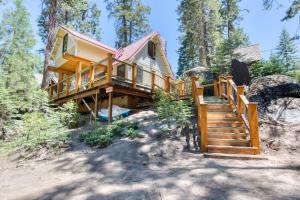 a house in the woods with stairs leading up to it at Bigfoot's Hideout in Shaver Lake