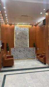 a lobby with chairs and a large marble wall at Rest inn in Medina