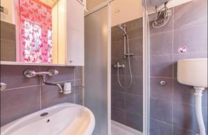 a bathroom with a sink and a shower at Two Room Eva in Pula +10 photos