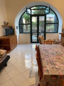 a living room with a table and a large window at Casa vacanze Sofia in Piano di Sorrento