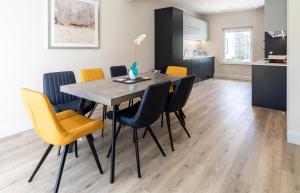 a kitchen and dining room with a table and chairs at Hilltown Lodge No3 in Hilltown