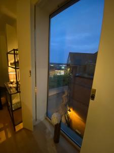 a view of a room with a large window at Central, modern and peaceful, lovely Cathedral views, two-bed apartment with 40" smart TV & free onsite parking in Lincoln