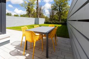 a table and chairs sitting on a patio at Hilltown Lodge No3 in Hilltown