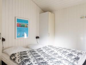 a bedroom with a bed and a picture on the wall at Enchanting Hideaway in Henne Town-By Traum in Henne Strand