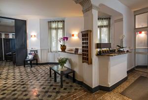 a living room with a counter and a table at Best Western Le Comtadin in Carpentras