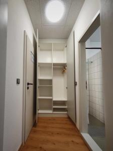 a hallway with a walk in closet and a light at Waldhotel am See Berlin-Schmöckwitz in Berlin