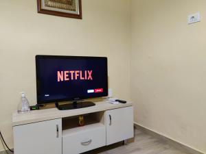 a television on a white cabinet with the netflix sign on it at Tirana City Center Apartment in Tirana