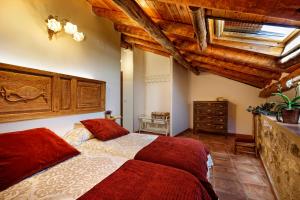 a bedroom with a large bed and wooden ceilings at Lagar de Justa in Adrados