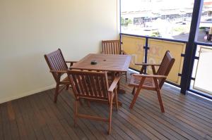a wooden table and chairs on a deck with a view of a harbor at The Australian Hotel Motel in Dalby