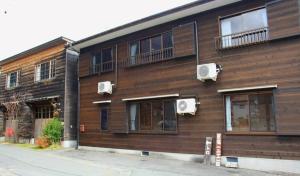 a wooden building with windows and air conditioners on it at Makino Kogen 123 Building - Vacation STAY 83784 in Kaizu