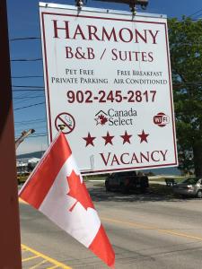 a sign with a canadian flag in front of a truck at Harmony B&B and Suites in Digby