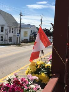 a flag in a bunch of flowers next to a street at Harmony B&B and Suites in Digby
