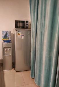 a microwave and a refrigerator in a room at Punta Cana Blue Beach Estudio in Punta Cana