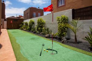 a miniature golf course in a backyard with a flag at Villa Leonor - Mirador de las Dunas in Corralejo