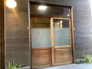 a wooden pivot door on the side of a building at Makino Kogen 123 Building - Vacation STAY 83784 in Kaizu