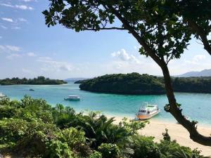 a beach with two boats in a body of water at Joya in Ishigaki Island