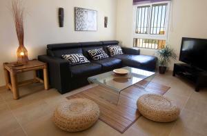 a living room with a couch and a coffee table at Tarifa Beach Rentals Almenara in Tarifa