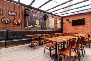 a dining room with wooden tables and chairs at Hotel Black Usaquen in Bogotá