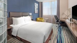 a large white bed in a hotel room at Holiday Inn Express Shenyang North Station, an IHG Hotel in Shenyang