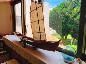 a wooden boat sitting on a window sill at Joya in Ishigaki Island