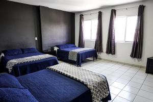 Postel nebo postele na pokoji v ubytování Hotel San Luis