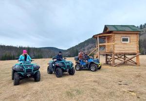 a group of people on atvs and a cabin at Eco Centre Talovskoe in Topilo