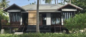a small house with a porch and some palm trees at Jasmine & Tea House in Mae Nam