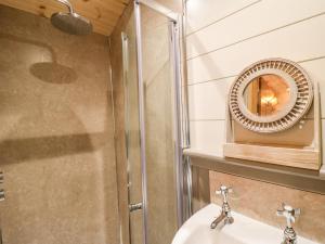 a bathroom with a sink and a mirror at The Lazy Mare by The Water in Rugeley