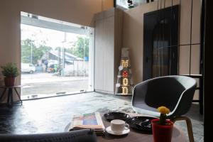 a living room with a chair and a table at Mayura Aureole CoLiving in Mumbai