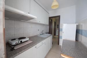 a kitchen with a sink and a toaster on a counter at Aris in Paralia Katerinis