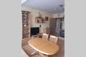 a kitchen and dining room with a table and chairs at Самостоятелен апартамент на брега на морето Обзор in Obzor