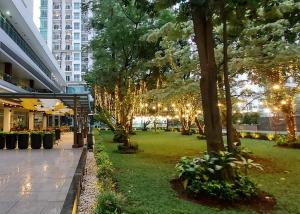 a park with christmas lights on trees in a city at Woodland Park Residence-Relaxed and Friendly in Jakarta