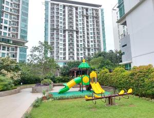 a playground in a park with a slide at Woodland Park Residence-Relaxed and Friendly in Jakarta