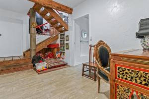 a living room with a fireplace and a chair at Balinese Beach House, Sunshine Beach in Sunshine Beach