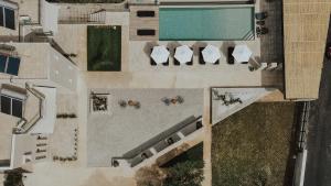 an overhead view of a pool with chairs and a swimming pool at Casa Costa Suites in Kanali