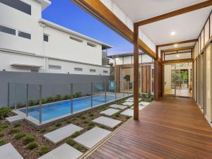 an external view of a house with a swimming pool at Beachfront Eclipse with Pool in Casuarina