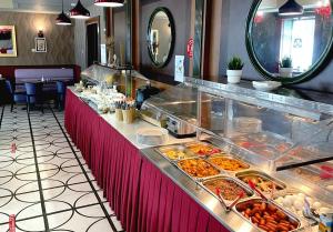 una línea de buffet con muchos tipos diferentes de comida en Matisov Domik Hotel near New Holland Island, en San Petersburgo