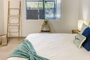 A bed or beds in a room at ZEN GARDEN - COZY 2-BR + Modern Design w/ Aircon