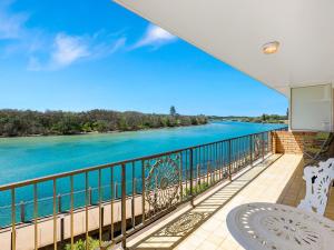 a balcony with a view of the water at Creekfront Kingscliff Waters 2 in Kingscliff