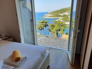 a room with a bed and a view of the ocean at Apartments Marijana in Zavalatica