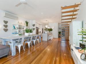 a kitchen and dining room with a table and chairs at COASTAL CHIC @ CASUARINA in Casuarina