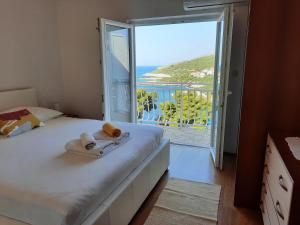a bedroom with a bed with a view of the ocean at Apartments Marijana in Zavalatica
