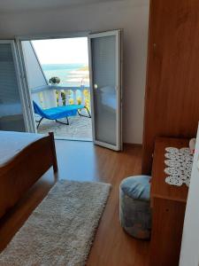 a bedroom with a bed and a door to a balcony at Apartments Marijana in Zavalatica