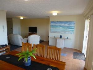 a living room with a table and chairs and a dining room at Saint Bernadine opposite Kingscliff Beach in Kingscliff