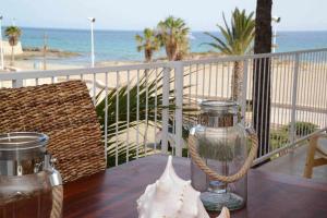 a table on a balcony with a view of the beach at Apartamento playa arenal Calpe Grupo Terra de Mar, alojamientos con encanto in Calpe